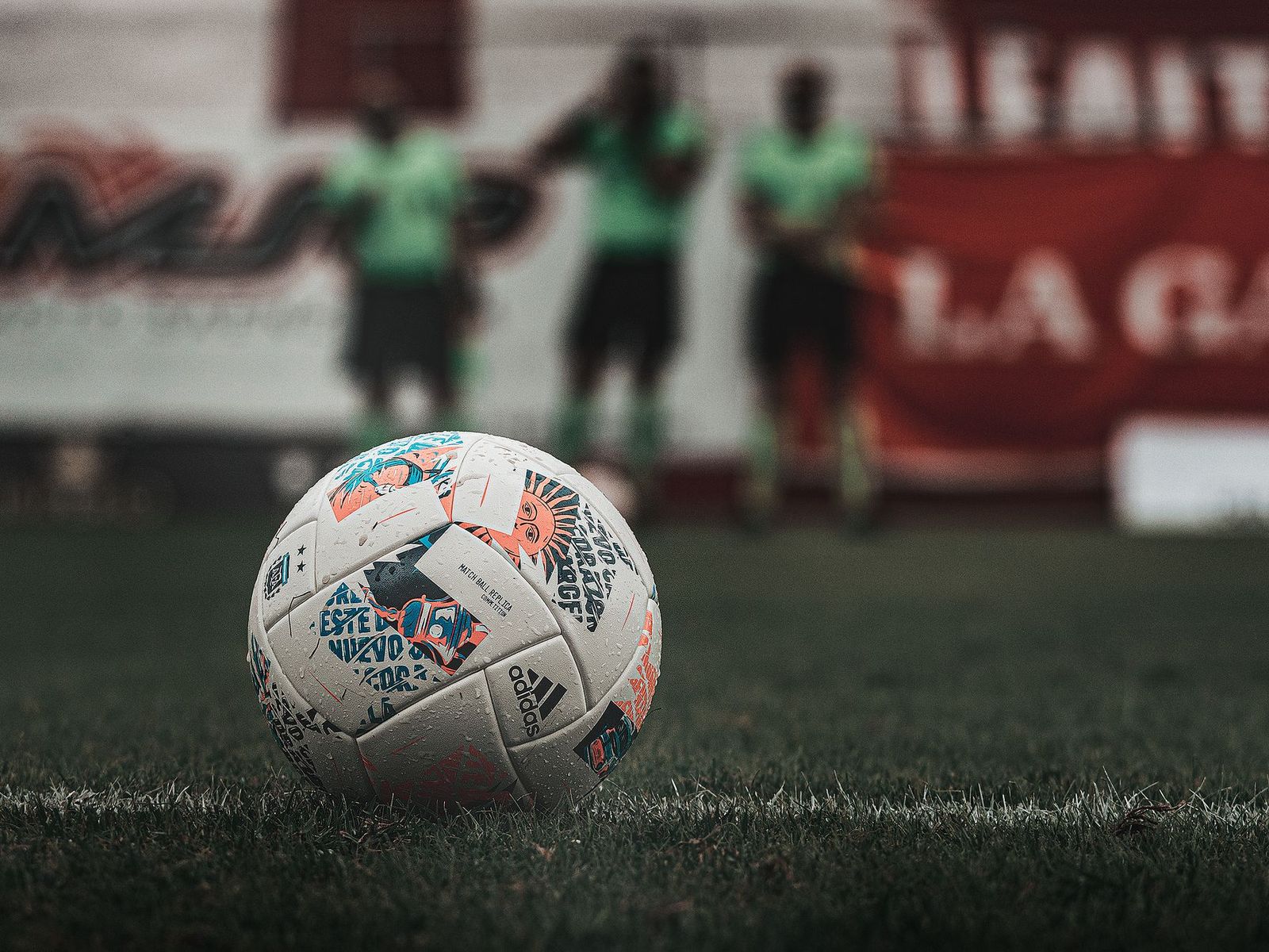 A football on a floodlit pitch